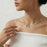 Two tone chain necklace with small dangling heart and drop charms evenly spaced, minimal elegant design