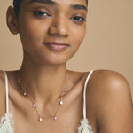 Blush pink charm drop chain necklace with delicate round pendants on a fine minimal chain