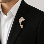 Crystal fish brooch with pearl accent and intricate stone detailing in rose gold finish