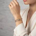 Triple tone mesh bracelet with gold silver and rose gold braided bands featuring crystal charm accents and clasp closure.