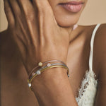 Triple tone mesh bracelet with gold silver and rose gold braided bands featuring crystal charm accents and clasp closure.