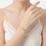Rose gold bracelet with crystal heart charms and delicate adjustable chain design for women