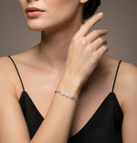 Rose gold triple halo bracelet with sparkling round stones and black bead chain detailing