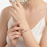 Rose gold bow charm bracelet with crystal accents and delicate chain design for women.