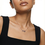 Rose gold infinity heart necklace with blue crystal accents and delicate heart charm design for women.