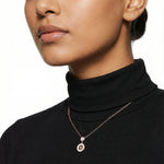 Rose gold celestial charm necklace with sparkling star pendant and circular white enamel design on delicate chain.