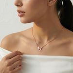 Rose gold orbit crystal necklace with circular pendant and sparkling stone accents
