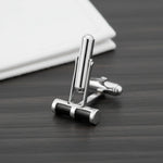 Black enamel barrel cufflinks with polished metallic finish for menβs formal wear and luxury shirt styling.