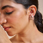 Rose gold heart cluster stud earrings with crystal accents and glossy white heart details