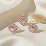 Rose gold heart-shaped pendant and earrings jewellery set with baguette crystals and halo stone detailing