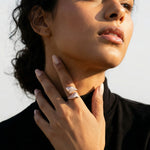 Rose gold geometric pyramid ring with sparkling crystal pave detailing on a modern luxury statement band for women.