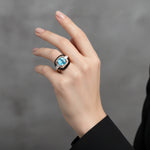 Luxury blue crystal halo ring with rose gold finish and black enamel detailing for women