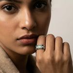 Luxury emerald baguette eternity ring with sparkling crystal accents in a polished silver-tone finish.