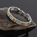 Modern dual tone link bracelet with silver frame and gold layered accents in a sleek contemporary design.