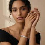 Elegant radiant baguette charm bracelet with sparkling stone detailing and sleek silver finish
