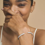 Elegant open cuff bracelet with sparkling crystal pave detailing and polished silver-tone finish