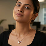 Rose gold circular pendant necklace with white enamel accents and sparkling stone detailing on a delicate chain.