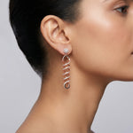 Rose gold spiral drop earrings with sparkling stone detailing and elegant twisted long dangle design for women.