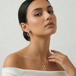Rose gold pearl oval pendant and earrings set with sparkling halo stones for women