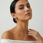 Rose gold rectangle pendant set with baguette crystal detailing and matching drop earrings