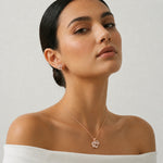 Rose gold infinity pendant and earrings set with baguette stones and sparkling crystal detailing for women.