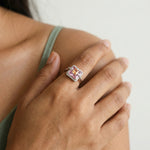 Luxury blush pink and peach crystal halo ring with square stones and sparkling designer band for women.