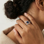 Luxury royal sapphire wave ring with blue square gemstone and sparkling crystal layered band design for women.