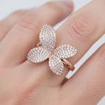 Rose gold floral crystal ring with sparkling pave petals and elegant open band design for women.