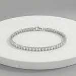 Elegant radiant crystal tennis bracelet with sparkling round stones and polished silver finish