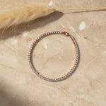 Luxury radiant rose gold tennis bracelet with sparkling crystal stones and elegant clasp design isolated