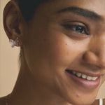 Elegant rose gold butterfly pendant necklace with matching blush pink crystal earrings displayed