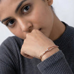 Rose gold open knot bracelet with sparkling stone detailing and minimal elegant design