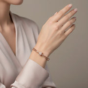 Rose gold double band bracelet with central stone detailing and adjustable chain clasp