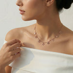 Rose gold necklace with delicate chain and small hexagon charm drops, minimal geometric jewellery design