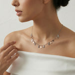 Dual tone teardrop charm necklace with alternating rose gold and silver drop pendants on a fine chain, minimal elegant design