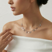 Dual tone teardrop charm necklace with alternating rose gold and silver drop pendants on a fine chain, minimal elegant design