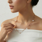 Layered pearl drop chain necklace with delicate gold chains and spaced pearl accents