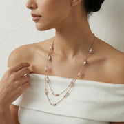 Layered pearl bead chain necklace with delicate dual chains and soft white pearl accents in a minimal elegant design
