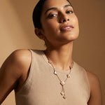 Blush clover layered drop necklace with floral charms and cascading design