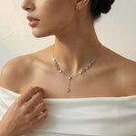Dual tone snowflake drop necklace set with matching earrings featuring silver and blush snowflake charms on a delicate chain.
