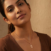 Rose gold oval drop necklace and earrings set with cutwork design and crystal accents
