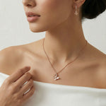 Rose gold butterfly pendant necklace with matching drop earrings featuring sparkling stone accents