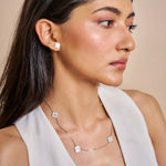 Minimal pink clover station necklace with delicate chain and evenly spaced floral charms
