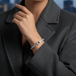 Silver crystal buckle bangle bracelet with belt-inspired clasp design
