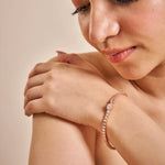 Rose gold teardrop crystal bracelet with dual band design and sparkling stones
