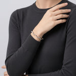 Geometric crystal wave cuff bracelet with sleek open bangle design and shimmering stone accents on a minimal silver-toned finish
