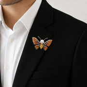 Amber crystal butterfly brooch with pearl centre and colourful stones, elegant statement pin design
