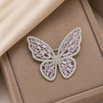 Pink crystal butterfly brooch pin with intricate wing design and sparkling stone detailing
