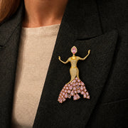 Pink crystal dancer brooch with gold finish and sparkling stones in elegant flowing dress design