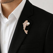 Crystal fish brooch with pearl accent and intricate stone detailing in rose gold finish
